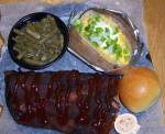 Half rack of baby back ribs with green beans and loaded baked potato
